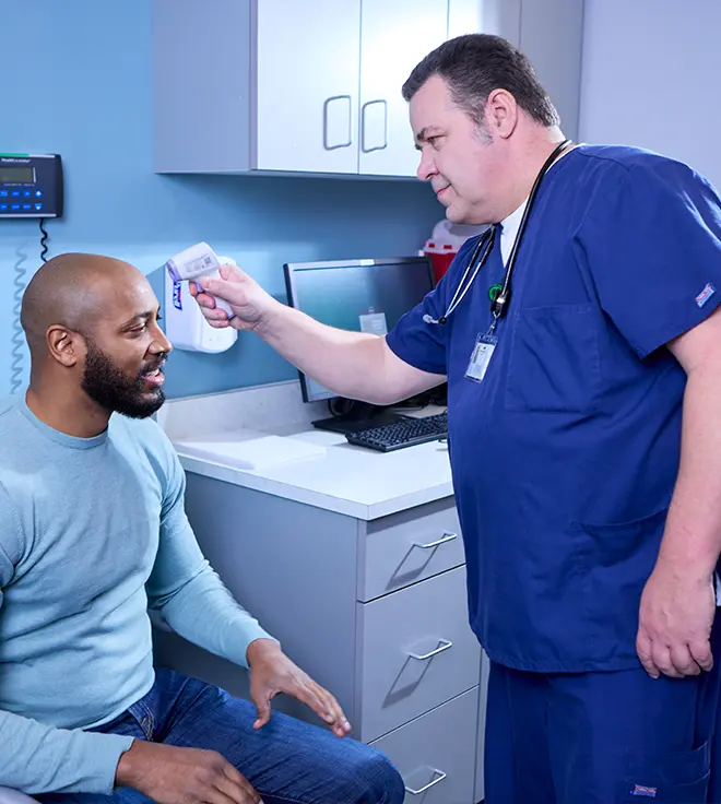 nurse taking the temperature of a patient