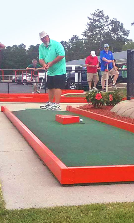 Christopher Taylor playing putt-putt golf