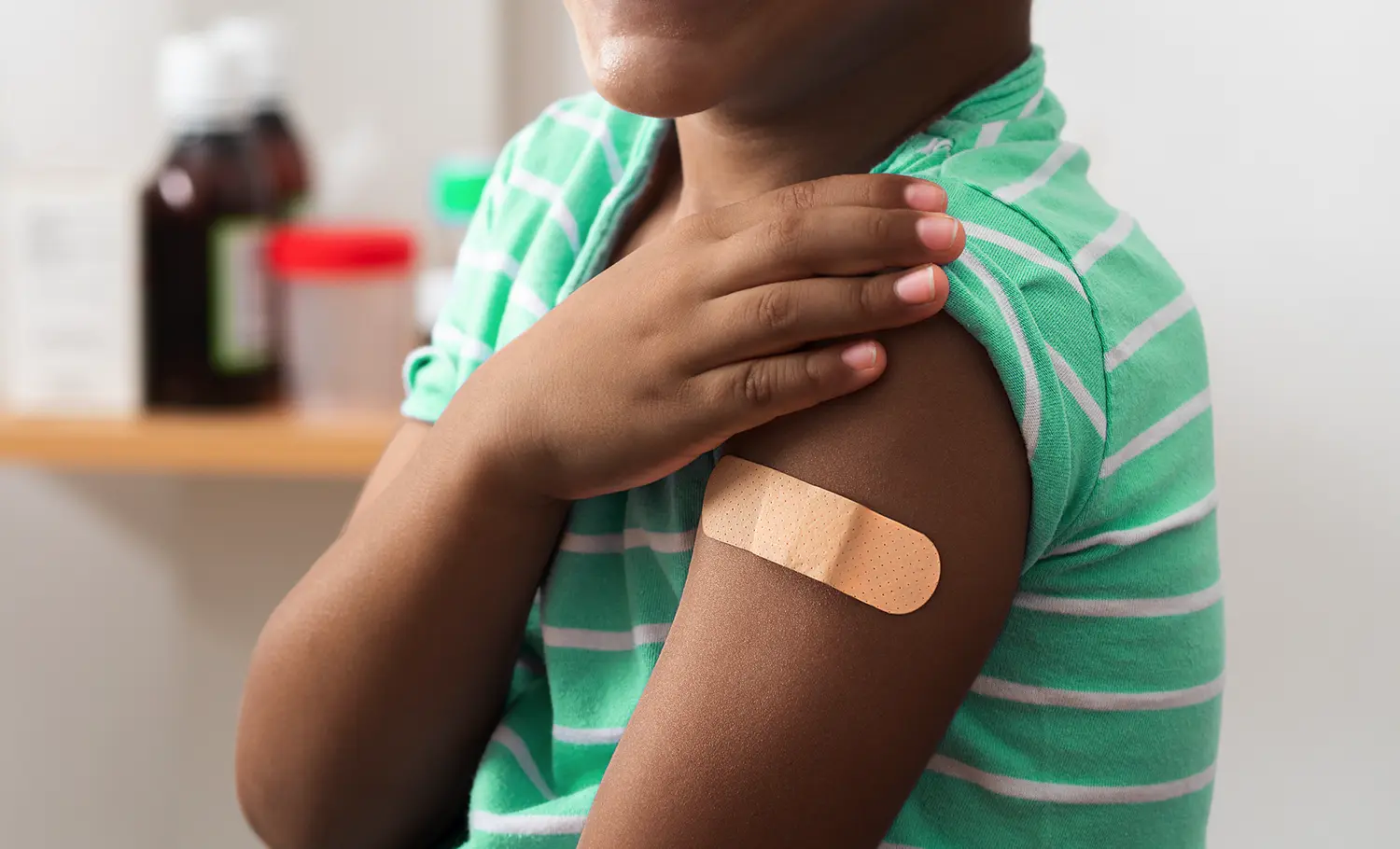 child with band-aid after getting the flu shot