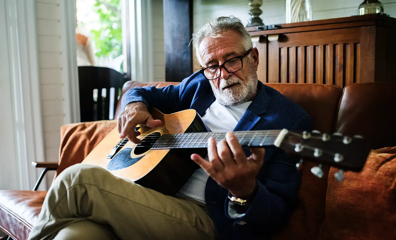 senior man playing the guitar