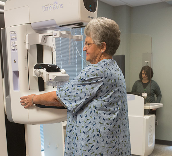 Judy receiving a mammogram