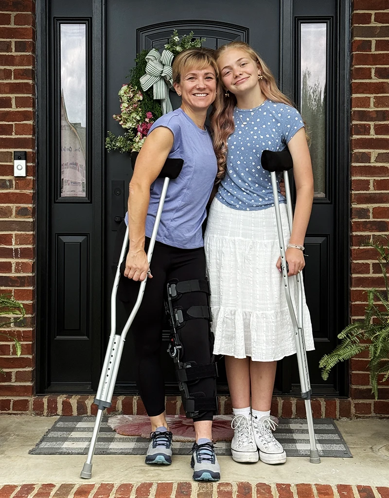 Dr. Campbell with leg brace and crutches