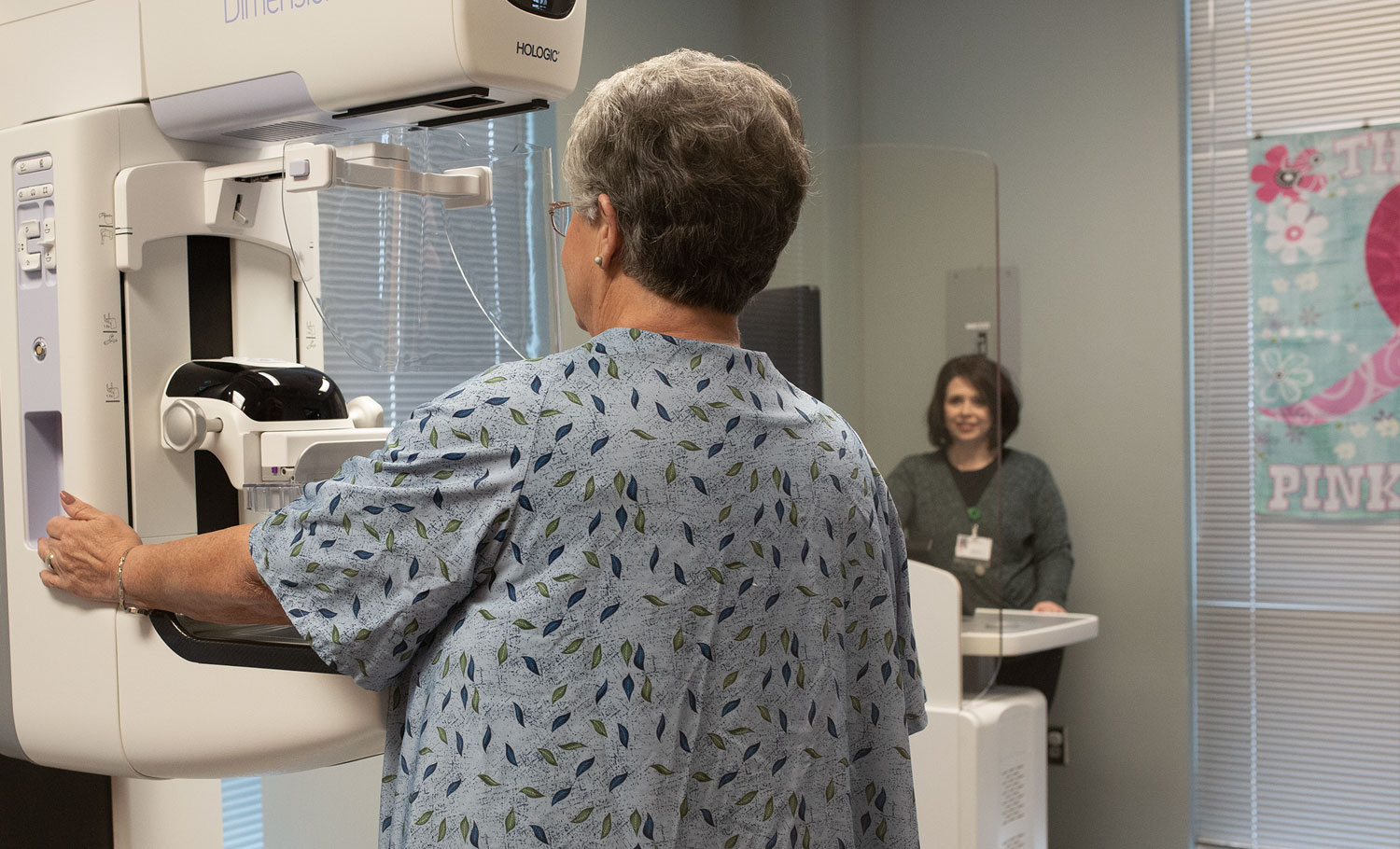 senior woman during a mammogram with technician