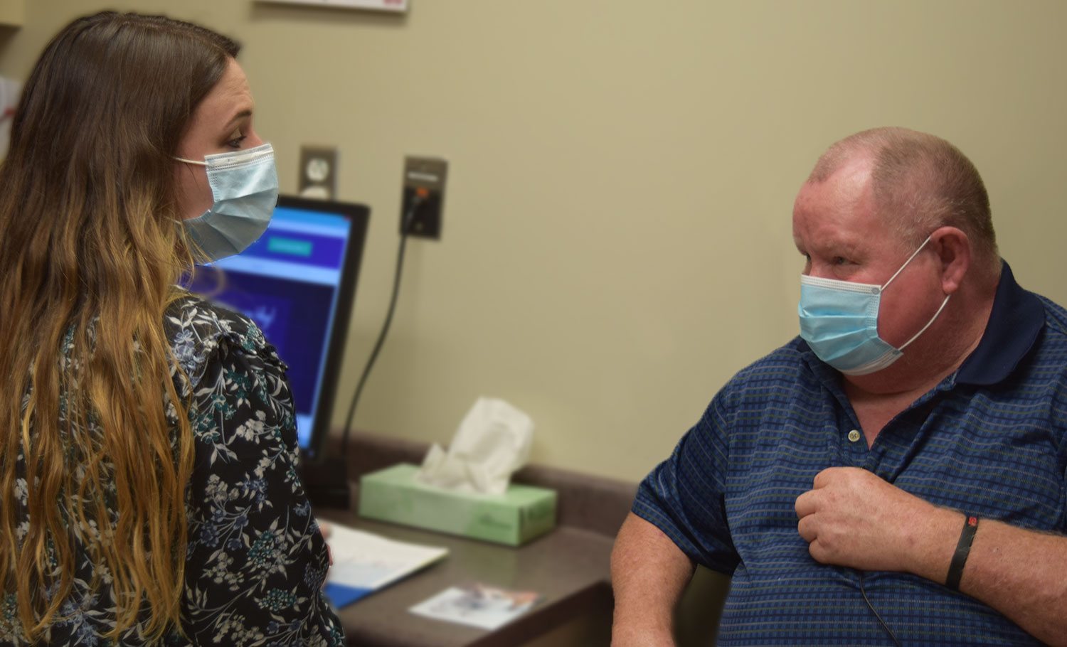 Quentin talking to a provider at HMG