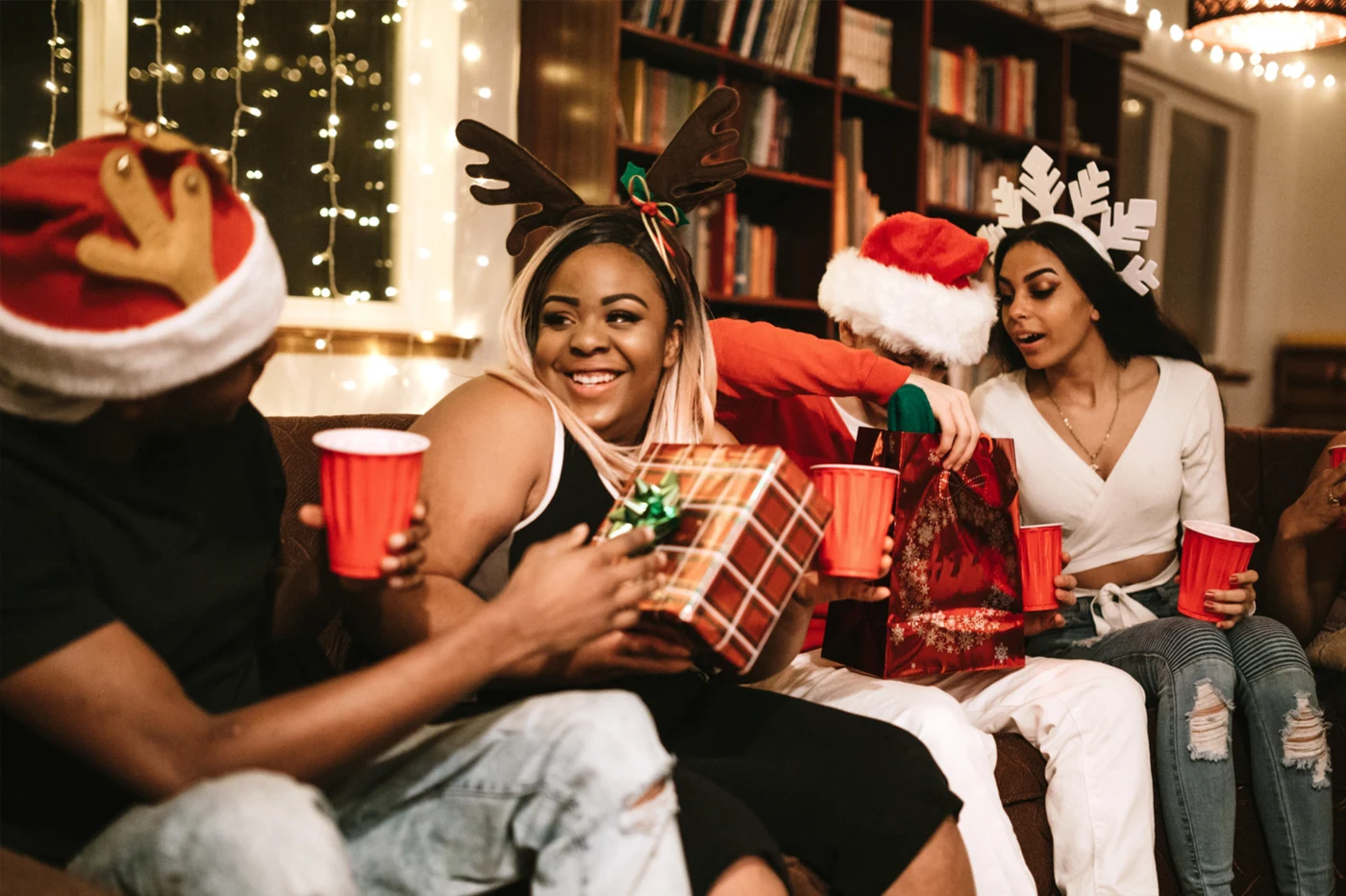 People on the couch opening gifts and celebrating