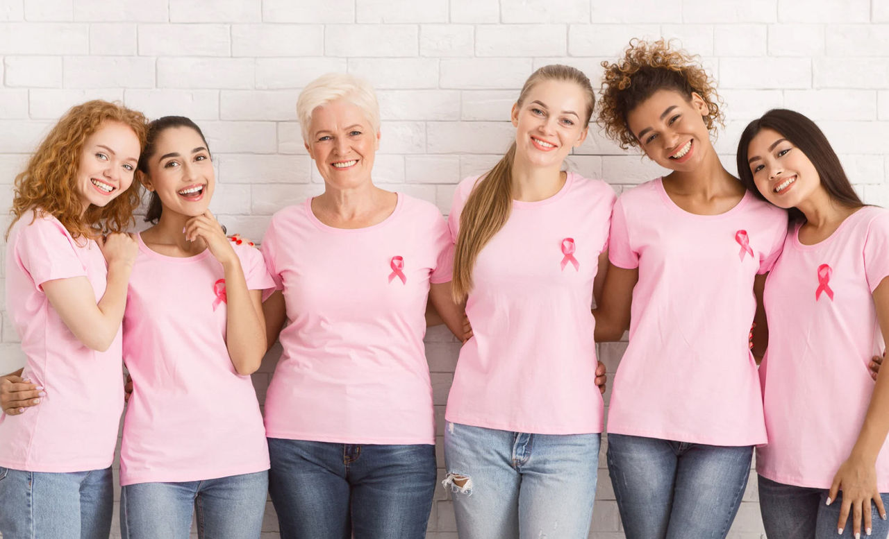 Group of women, all ages, with pink shirts