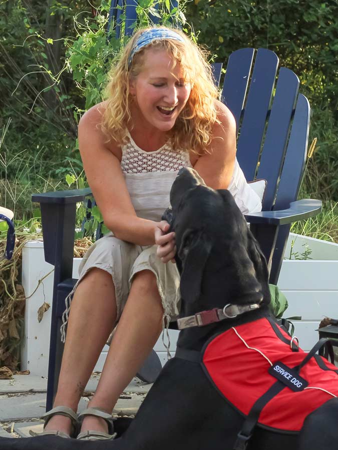 Person interacting with a service dog outdoors