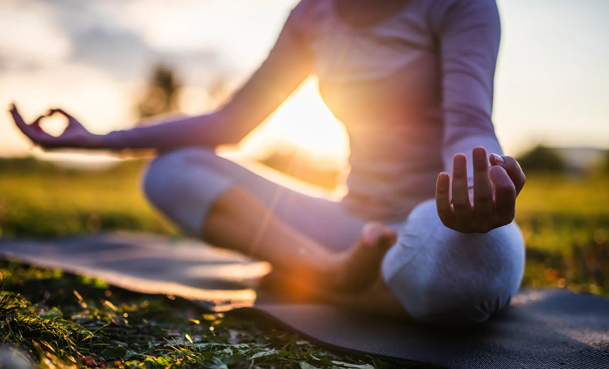 woman doing yoga at sunrise