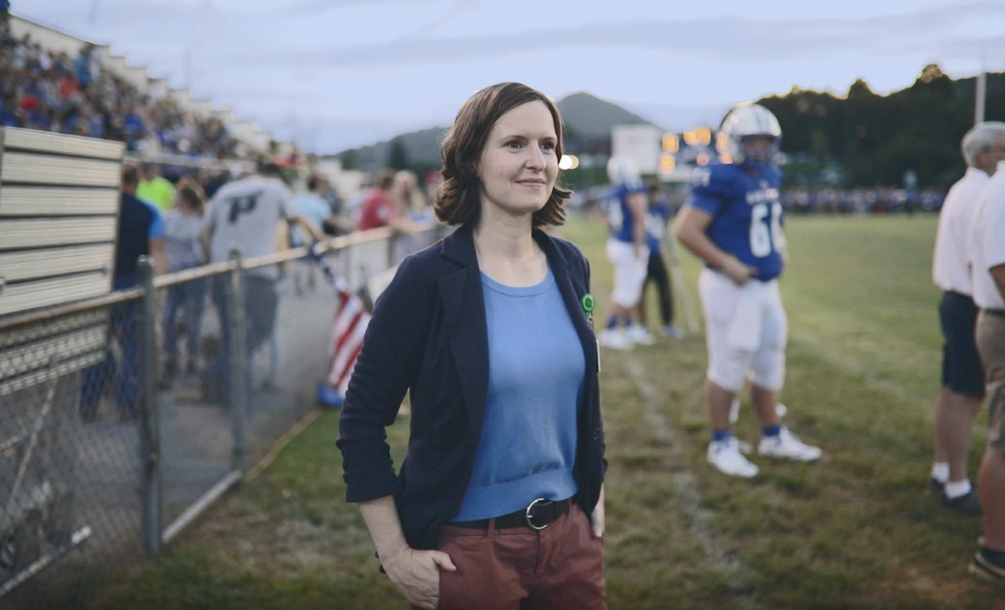 Dr. Remy watching football players during a game