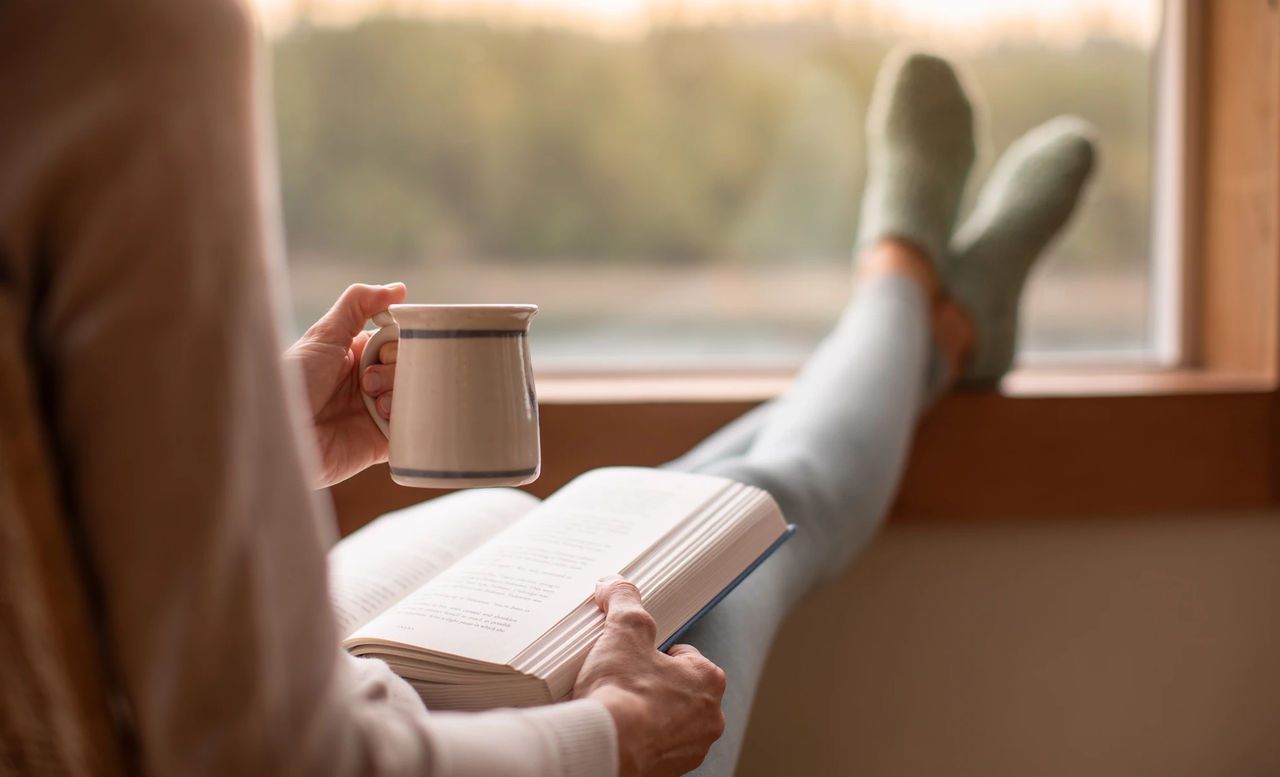 Person relaxing with coffee in the morning