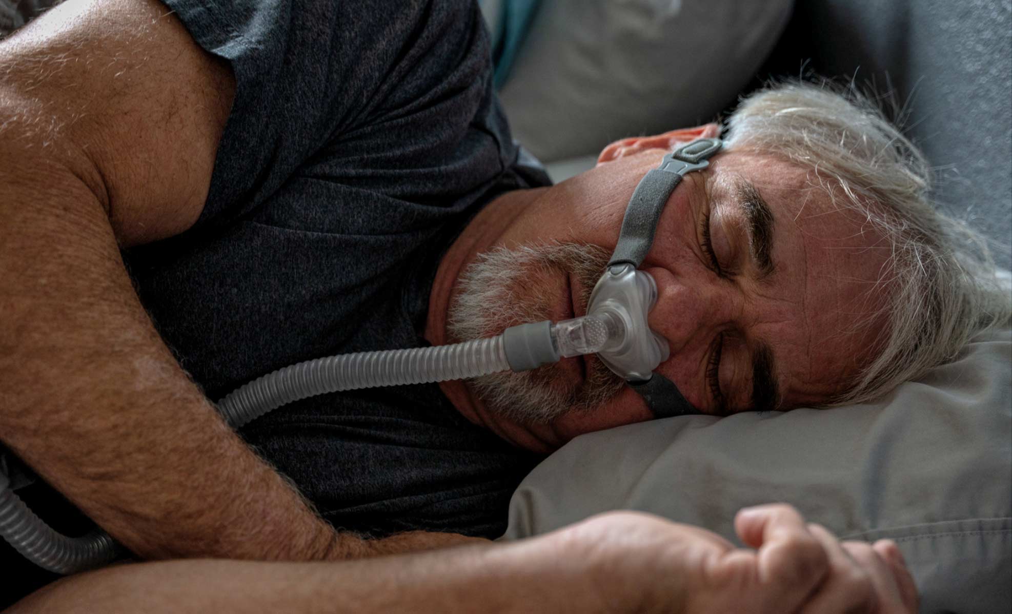 man sleeping with a CPAP machine