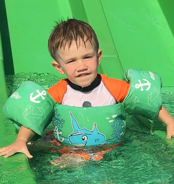 child in the water with puddle jumpers