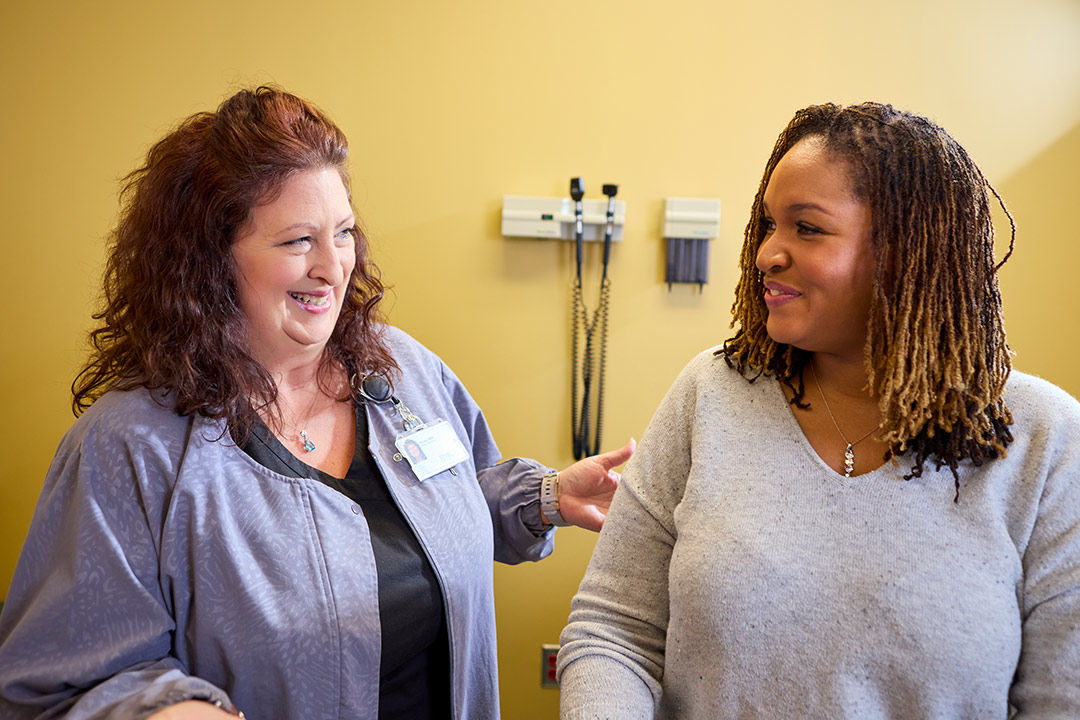 Nurse and patient talking during an exam