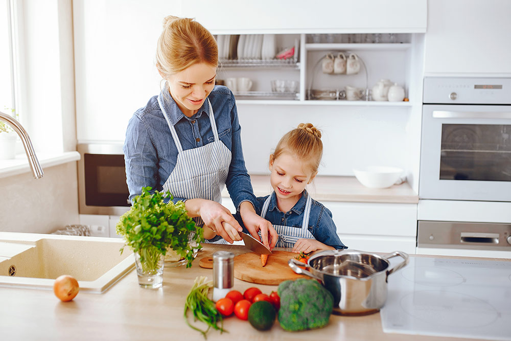 mom and daughter cooking healthy food