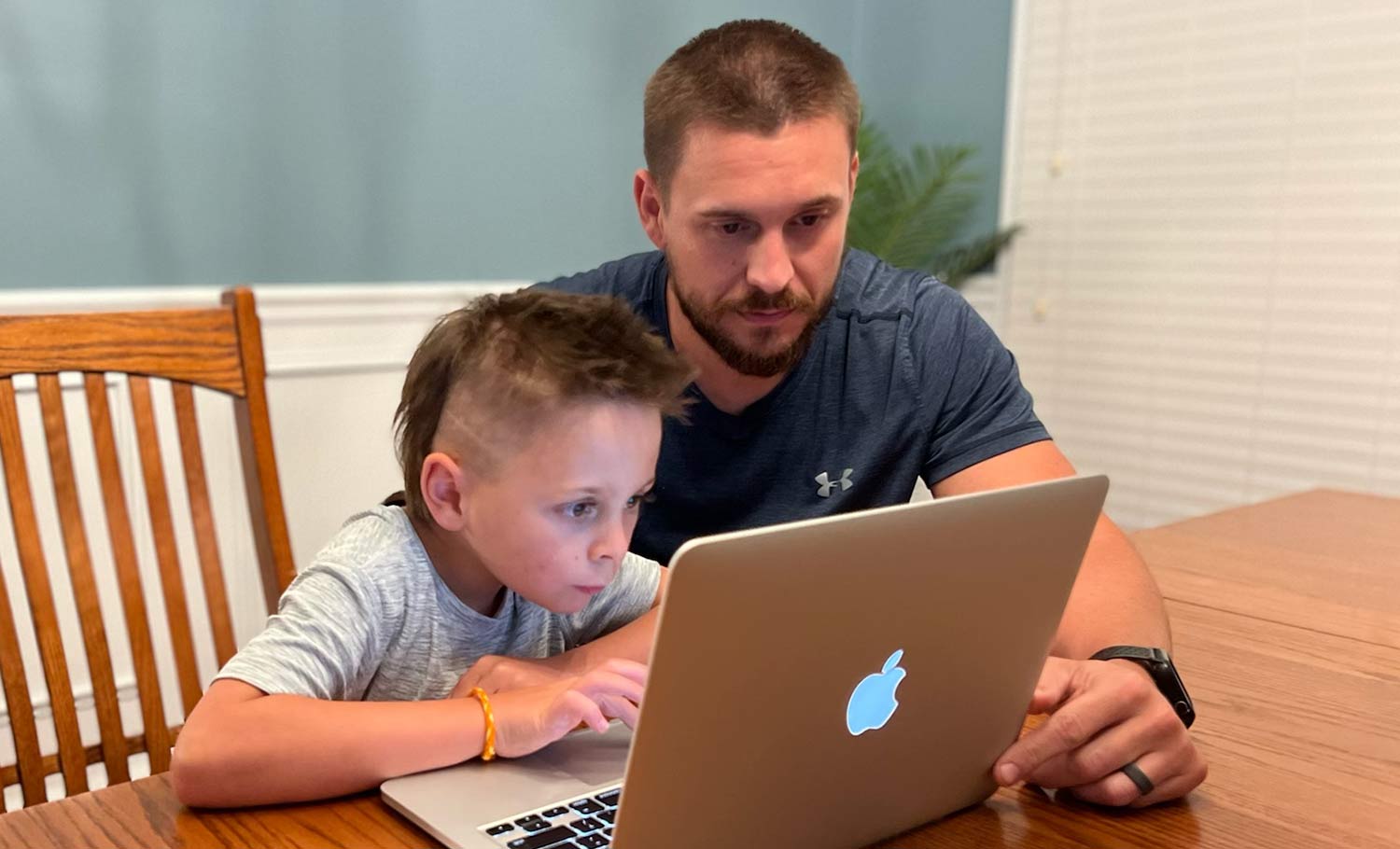 father helping son study