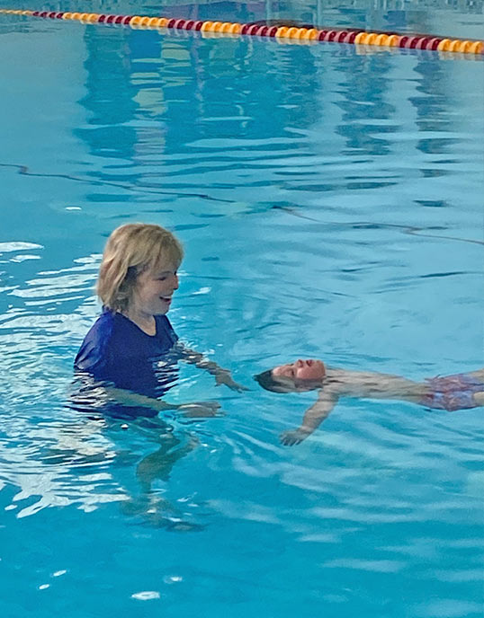 swimming instructor with child