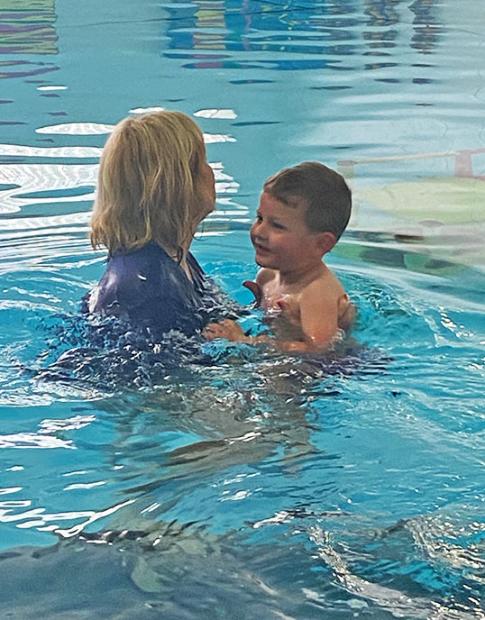 swimming instructor with child