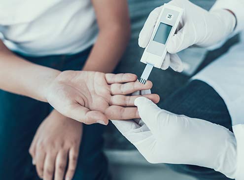 patient performing a diabetes test