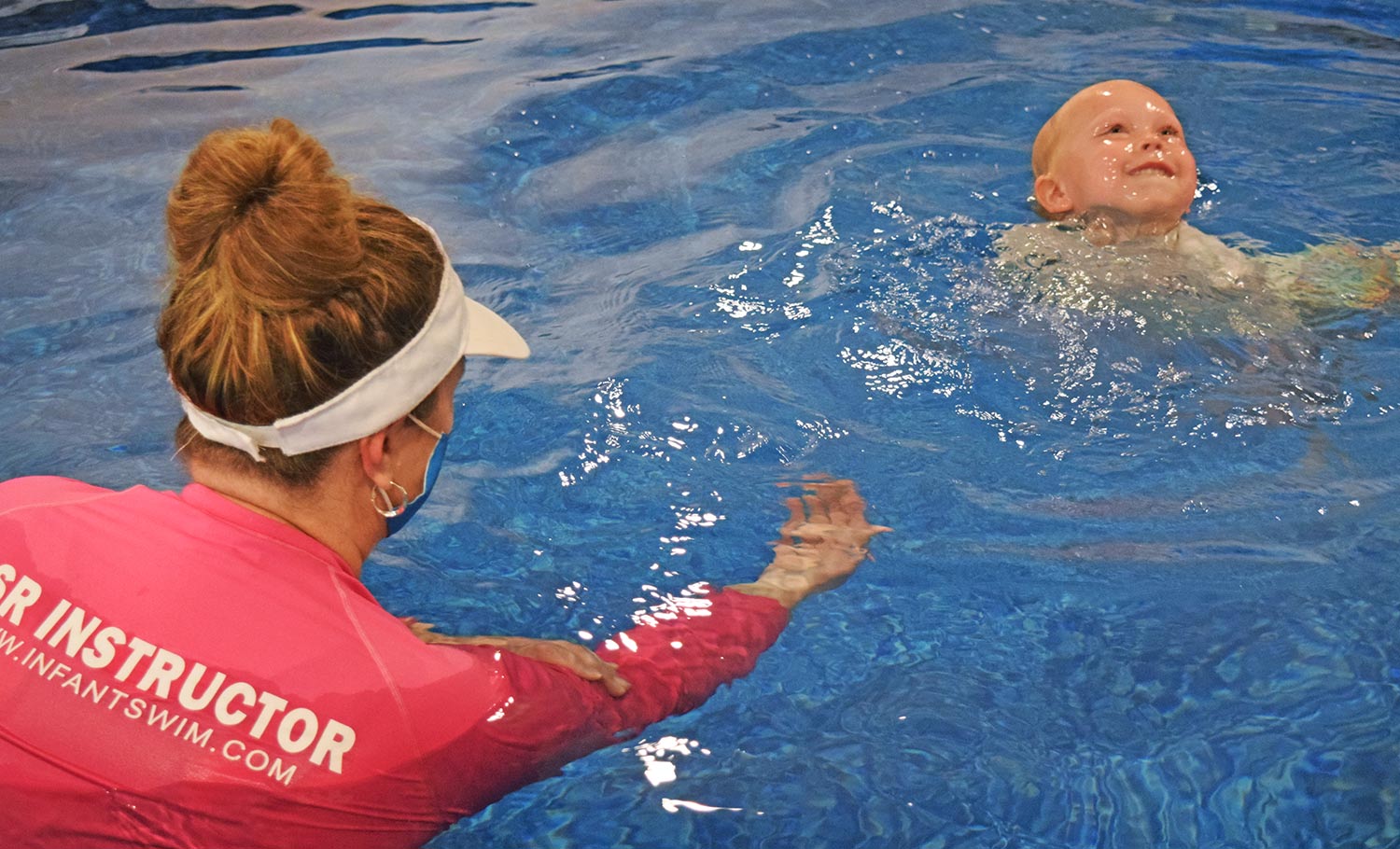 child and adult swimming