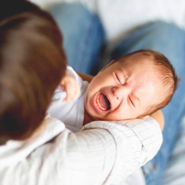 dad holding crying baby